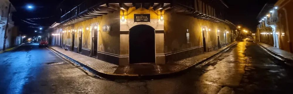 Un bâtiment de style colonial à l'angle d'une rue du Nicaragua, éclairé de nuit